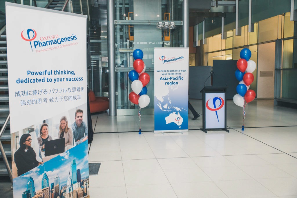 Branded banners and balloons in an office lobby for Oxford PharmaGenesis