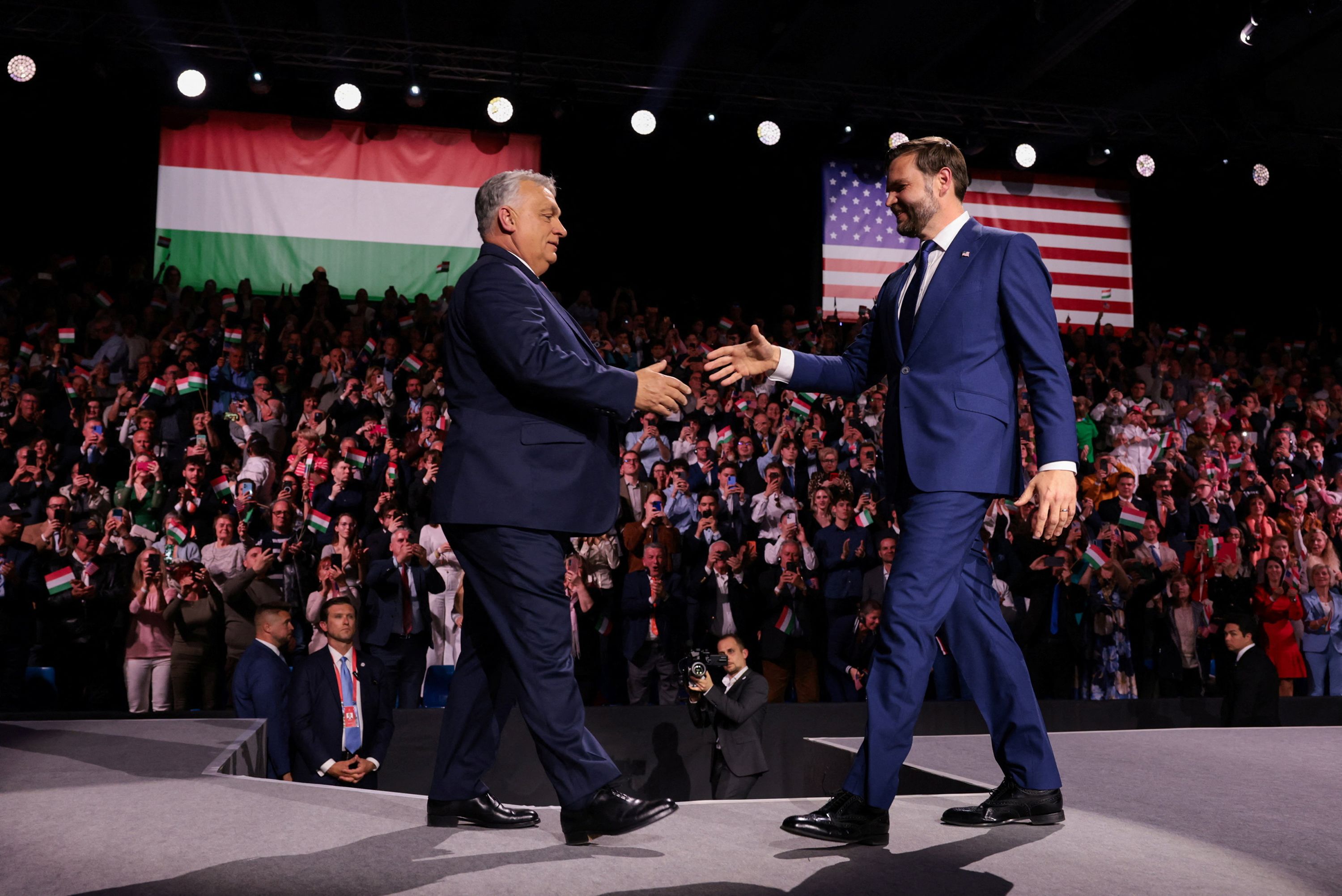 U.S. Vice President JD Vance and Hungarian Prime Minister Viktor Orban walk to shake hands on stage during Day of Friendship event at MTK Sportpark in Budapest, Hungary, April 7, 2026.