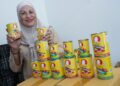 SALMAH Abu Bakar menunjukkan produk sardin keluarannya yang mula menembusi pasar raya besar baru-baru ini.